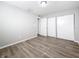 Bright bedroom featuring wood-look flooring, closet, and window allowing natural light at 3124 61St N Ln, St Petersburg, FL 33710