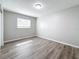 Cozy bedroom with gray walls, wood-look flooring, and a window providing natural light at 3124 61St N Ln, St Petersburg, FL 33710