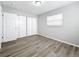 Bright bedroom featuring wood-look flooring, closet, and window allowing natural light at 3124 61St N Ln, St Petersburg, FL 33710
