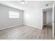 Bright bedroom features wood-look flooring, and a window providing natural light at 3124 61St N Ln, St Petersburg, FL 33710