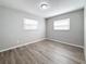 Cozy bedroom with gray walls, wood-look flooring, and a window providing natural light at 3124 61St N Ln, St Petersburg, FL 33710