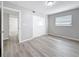 Bright bedroom featuring wood-look flooring, closet, and window allowing natural light at 3124 61St N Ln, St Petersburg, FL 33710