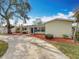 Well-maintained home with a neatly landscaped front yard and a long driveway at 3124 61St N Ln, St Petersburg, FL 33710