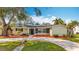 Charming home with a manicured lawn, mulch landscaping, and an inviting entryway at 3124 61St N Ln, St Petersburg, FL 33710
