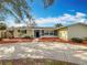 Charming single-story home with a well-maintained front yard, vibrant landscaping, and a welcoming entrance at 3124 61St N Ln, St Petersburg, FL 33710