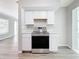 Kitchen with stainless steel oven and stove with white cabinets at 3124 61St N Ln, St Petersburg, FL 33710