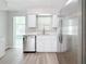 Stainless steel dishwasher and refrigerator with white cabinets at 3124 61St N Ln, St Petersburg, FL 33710