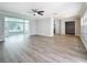 Spacious living room with stylish gray flooring, modern fan, and an open layout at 3124 61St N Ln, St Petersburg, FL 33710
