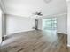 Bright living room featuring wood-look floors and views into the sunroom at 3124 61St N Ln, St Petersburg, FL 33710