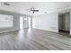 Bright living room with ceiling fan, wood flooring, and an ornate front door at 3124 61St N Ln, St Petersburg, FL 33710