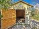 The open doors of this backyard shed reveal ample storage space and easy access at 3124 61St N Ln, St Petersburg, FL 33710