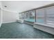 Bright sunroom with tiled flooring, large windows with blinds, and built-in bench seating at 3124 61St N Ln, St Petersburg, FL 33710