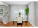 Bright dining room with a round table, white chairs, hardwood floors, and sheer curtains at 313 27Th N St, St Petersburg, FL 33713