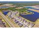 Stunning aerial view of a Primary-planned community, showcasing water views and well-manicured lawns at 3133 King Fern Dr, Wimauma, FL 33598