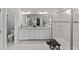 Bathroom featuring a double sink vanity, granite countertops, and a tiled walk-in shower with a bench at 3133 King Fern Dr, Wimauma, FL 33598