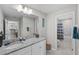 Bathroom featuring a white vanity with a gray granite countertop and a tub with a shower at 3133 King Fern Dr, Wimauma, FL 33598