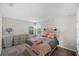 Bedroom with a queen bed, dresser, and two windows offering backyard views for natural light at 3133 King Fern Dr, Wimauma, FL 33598
