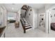 Open foyer with tile floors, a staircase with wrought iron railings, and a half bathroom at 3133 King Fern Dr, Wimauma, FL 33598