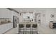 Modern kitchen featuring white cabinetry, granite countertops, stainless steel appliances, and a large central island at 3133 King Fern Dr, Wimauma, FL 33598