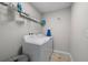 Efficient laundry room with modern washer and dryer and practical shelving for storage at 3133 King Fern Dr, Wimauma, FL 33598