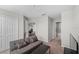 Neutral living room with a gray couch, a table, and an entrance to the game room and bathroom at 3133 King Fern Dr, Wimauma, FL 33598