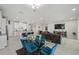 Open-concept living space with a modern kitchen, dining area, and a comfortable seating area with a large television at 3133 King Fern Dr, Wimauma, FL 33598