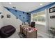 Comfortable home office with a large desk, a plush chair, and natural light from a window at 3133 King Fern Dr, Wimauma, FL 33598