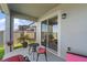 Relaxing covered patio featuring a small table with seating and an outdoor serving area at 3133 King Fern Dr, Wimauma, FL 33598