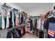 Walk-in closet with ample storage space featuring metal shelving and hanging rods for clothing and accessories at 3133 King Fern Dr, Wimauma, FL 33598