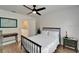 Bright bedroom features a metal bed frame, white linens, hardwood floors and ceiling fan at 3308 W Santiago St # B, Tampa, FL 33629