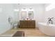 Bright bathroom with dual vanity, free standing tub, and glass shower at 33277 Rosewood Bark Way, Wesley Chapel, FL 33545