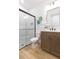 Bathroom features a large shower with glass door, sink, and tile floors at 33277 Rosewood Bark Way, Wesley Chapel, FL 33545
