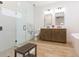 Bright bathroom with dual vanity, walk-in shower, and modern fixtures at 33277 Rosewood Bark Way, Wesley Chapel, FL 33545