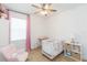 Bedroom features a crib, rocker, and neutral floors at 33277 Rosewood Bark Way, Wesley Chapel, FL 33545