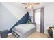 This bedroom features a built-in bed with storage and stylish gray and blue wall accents at 33277 Rosewood Bark Way, Wesley Chapel, FL 33545