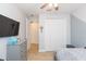 Neutral bedroom with tile floors, dresser, and a large closet at 33277 Rosewood Bark Way, Wesley Chapel, FL 33545