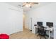 Bedroom featuring tile floors, closet, and white desk at 33277 Rosewood Bark Way, Wesley Chapel, FL 33545