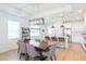 Beautiful dining area with a modern chandelier, stylish furnishings, and an open layout to the gourmet kitchen at 33277 Rosewood Bark Way, Wesley Chapel, FL 33545