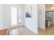 Inviting foyer with a decorative front door, stylish flooring, and access to a well-appointed bathroom at 33277 Rosewood Bark Way, Wesley Chapel, FL 33545