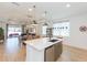 Spacious kitchen featuring a large center island, stainless steel appliances, and seamless flow to the living areas at 33277 Rosewood Bark Way, Wesley Chapel, FL 33545