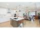 Open-concept kitchen featuring a center island, stainless steel appliances, and seamless integration with the dining and living areas at 33277 Rosewood Bark Way, Wesley Chapel, FL 33545