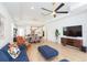 Spacious living area with an open floor plan, connecting the living room, dining area, and kitchen for modern living at 33277 Rosewood Bark Way, Wesley Chapel, FL 33545