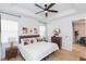 Bright main bedroom with ceiling fan, wood floors, and modern decor at 33277 Rosewood Bark Way, Wesley Chapel, FL 33545