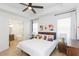 Bright main bedroom with ceiling fan, ensuite bathroom, and modern decor at 33277 Rosewood Bark Way, Wesley Chapel, FL 33545