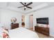 Bright main bedroom with ceiling fan, wood floors, and modern decor at 33277 Rosewood Bark Way, Wesley Chapel, FL 33545