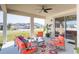 Charming covered patio with stylish seating, creating an inviting outdoor living space at 33277 Rosewood Bark Way, Wesley Chapel, FL 33545