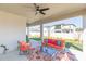 Comfortable covered patio with a ceiling fan, ideal for relaxing and enjoying the outdoor view at 33277 Rosewood Bark Way, Wesley Chapel, FL 33545