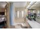 Bathroom featuring a tub with shower curtain and shelving with towels and toiletries at 35020 Colony Hills Dr, Zephyrhills, FL 33541