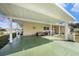 Spacious carport offering covered parking and a cozy seating area, perfect for enjoying the outdoors at 35020 Colony Hills Dr, Zephyrhills, FL 33541
