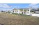 Charming yellow single-story home with a covered carport and well-manicured lawn, showcasing classic curb appeal at 35020 Colony Hills Dr, Zephyrhills, FL 33541